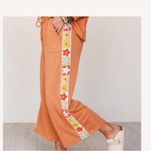Three Bird Nest Orange Pants with Floral Trim